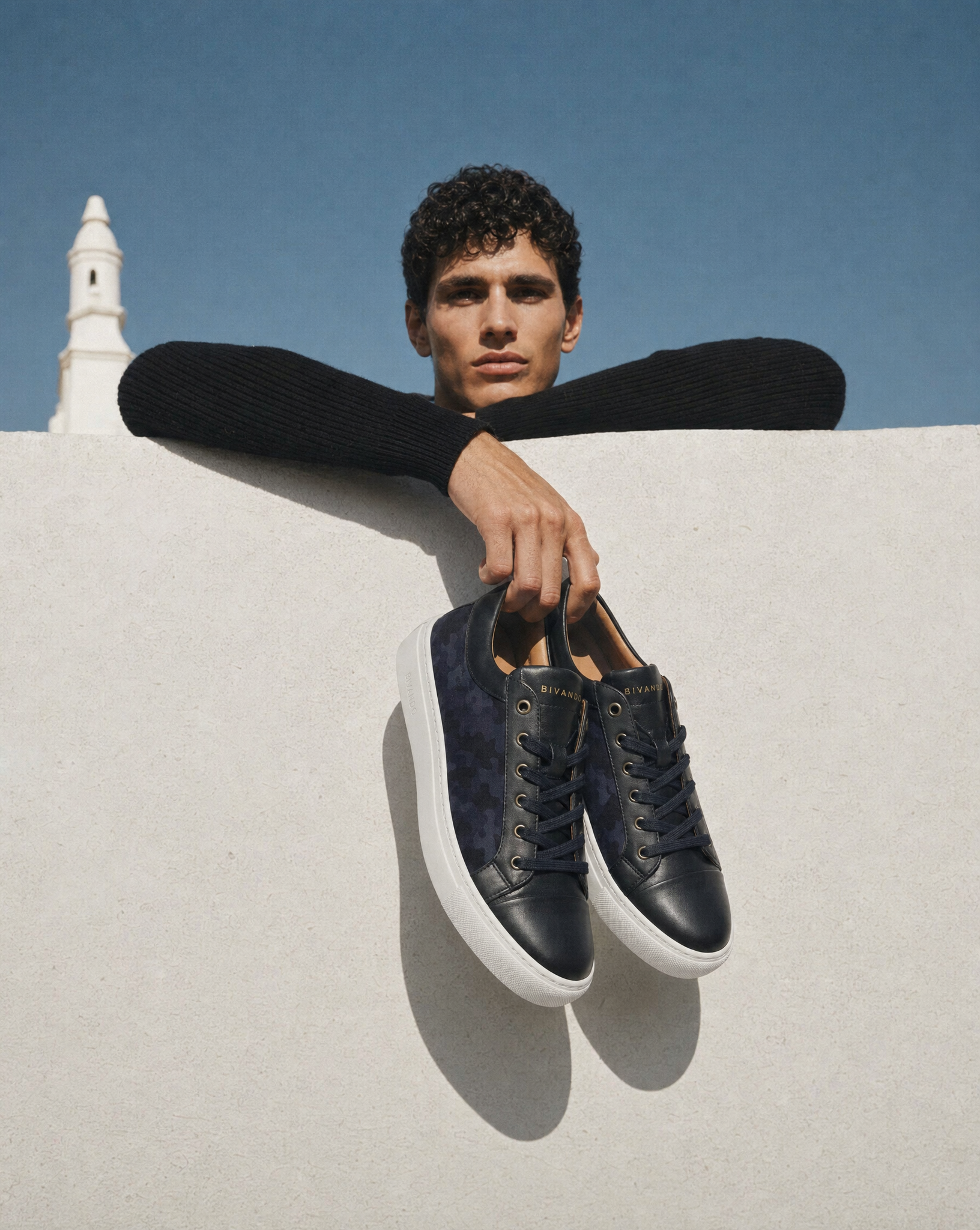 Man holding Bivando navy camo low top sneakers in Portugal

