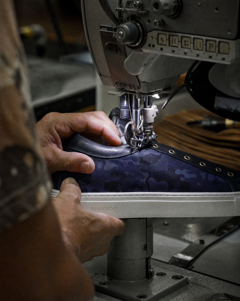 Handcrafted Bivando navy camo sneaker being sewn in Portugal